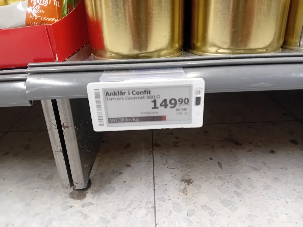 A close-up of a supermarket price tag for 'Anklår i Confit' (cured calf's foot) showing a price of 149.90 kr for 800g, with…
