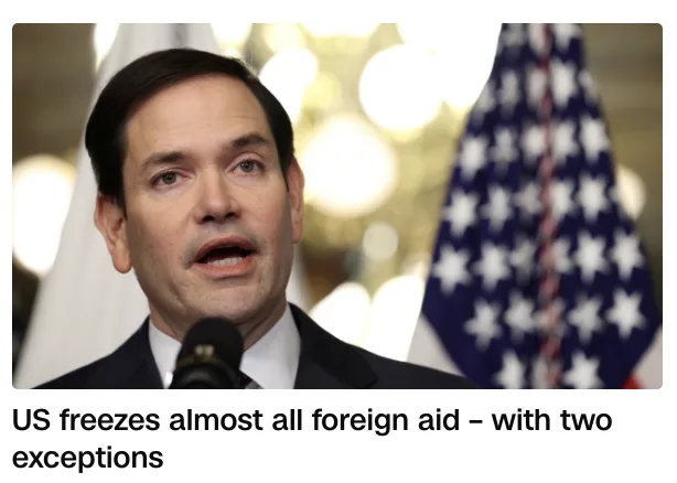 A man in a suit speaks into a microphone with an American flag visible behind him. The overlaid text reads 'US freezes…