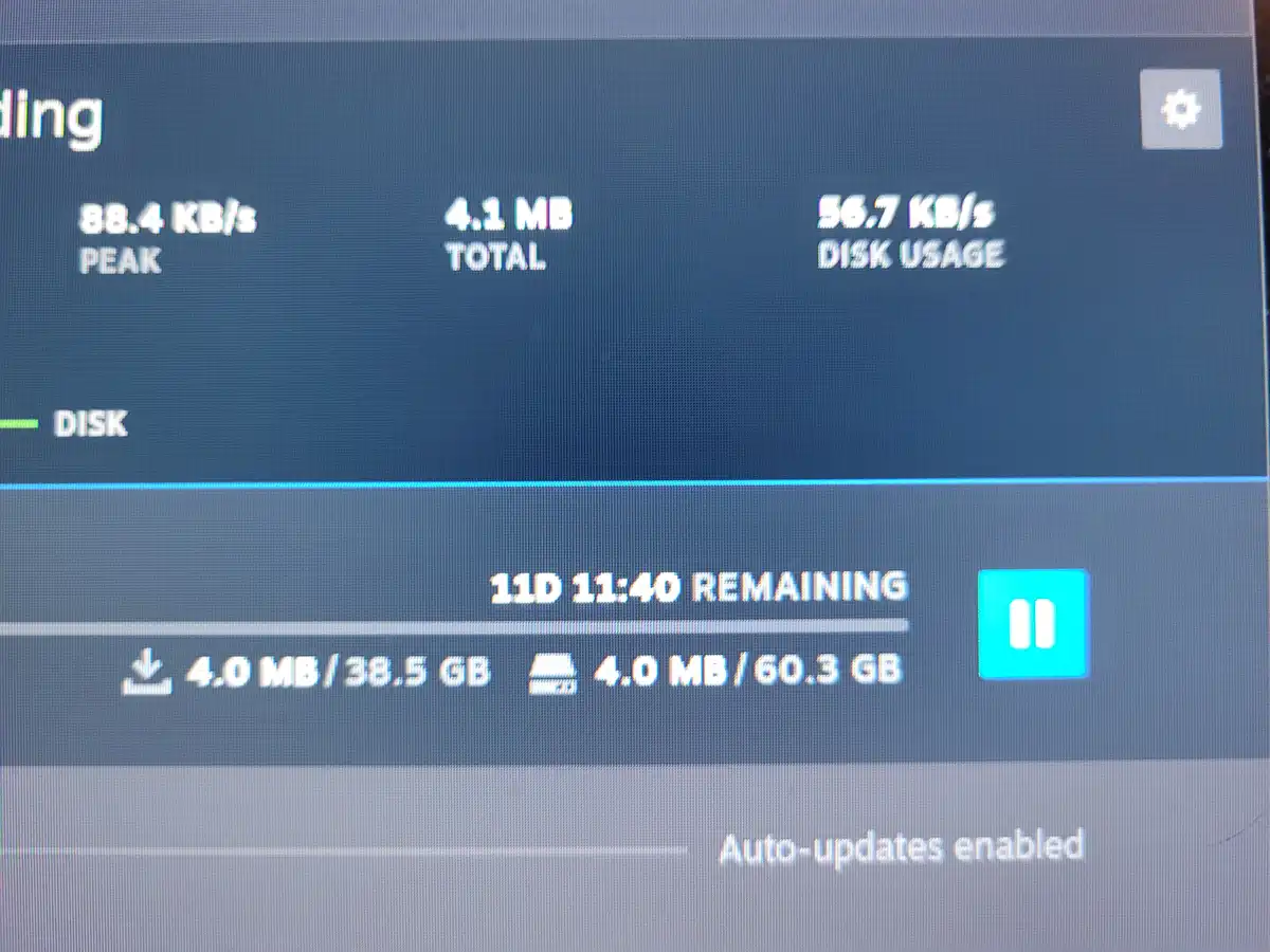 A computer screen shows a download progress bar with '11D 11:40 REMAINING' indicating 11 days and 11 hours left. The…