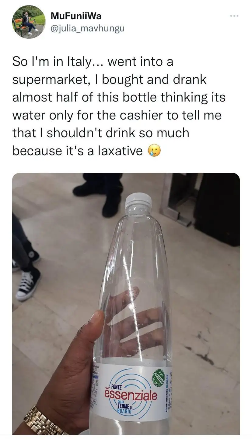 A person holds up a nearly empty plastic water bottle labeled 'Fonte Essenziale' in a supermarket. The overlaid text…