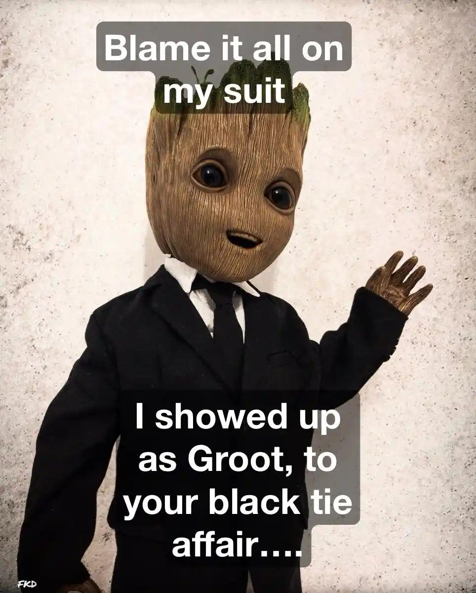 A small, tree-like humanoid character with a wooden face and green sprouts on top, dressed in a black suit and tie, waves…