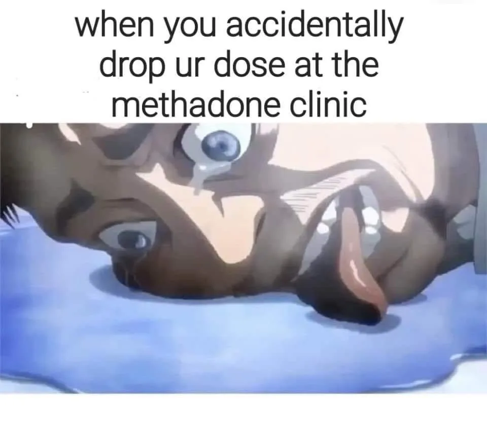 An anime character with wide, terrified eyes and a gaping mouth lies face-down in a pool of blue liquid, conveying extreme…