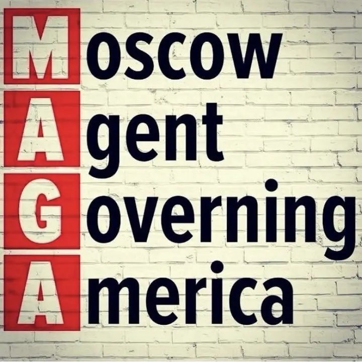 The image displays a white brick wall with large black text that reads 'MOSCOW gent overnning merica', where the letters…