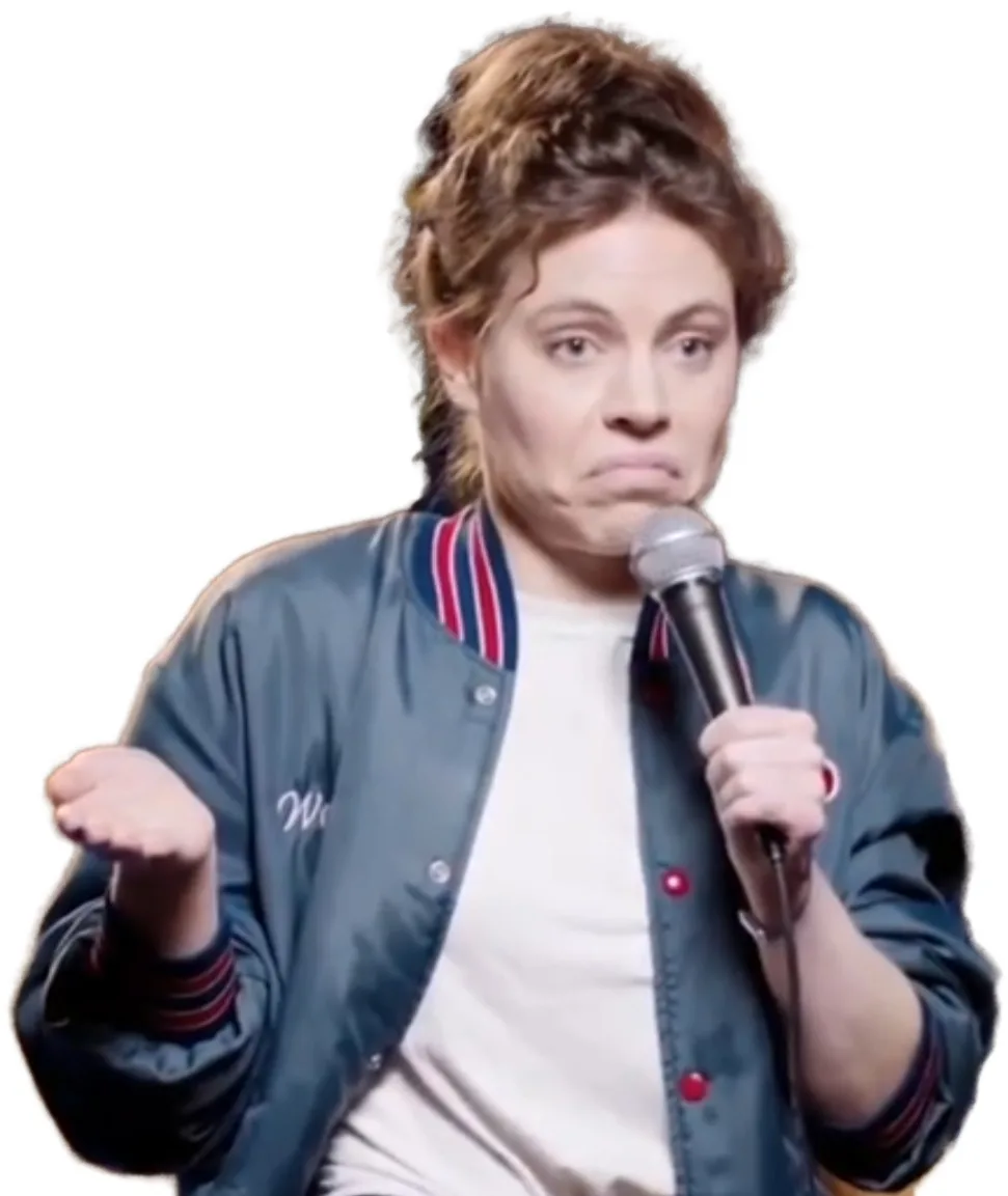 a person with curly brown hair wearing a dark blue bomber jacket with red and white striped collar and cuffs, over a white…