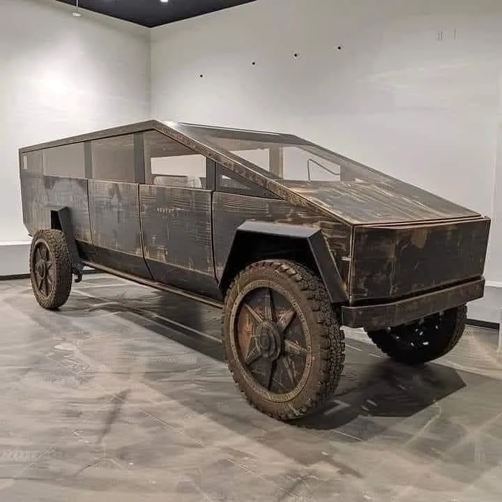 a tesla cybertruck is displayed in a gallery setting, but its entire exterior has been heavily modified to look like it's…