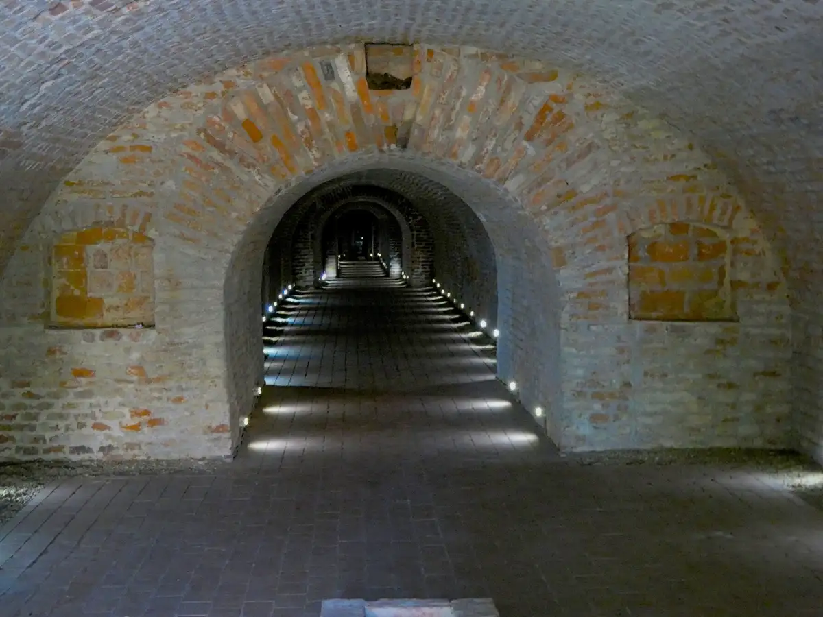Explore the Enigmatic Brick Tunnels Illuminated by Soft Lights Leading into Mystery