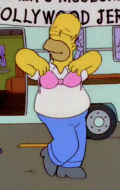 Homer Simpson, a yellow-skinned cartoon character with a large belly, is shown wearing a pink bra over a white t-shirt and…