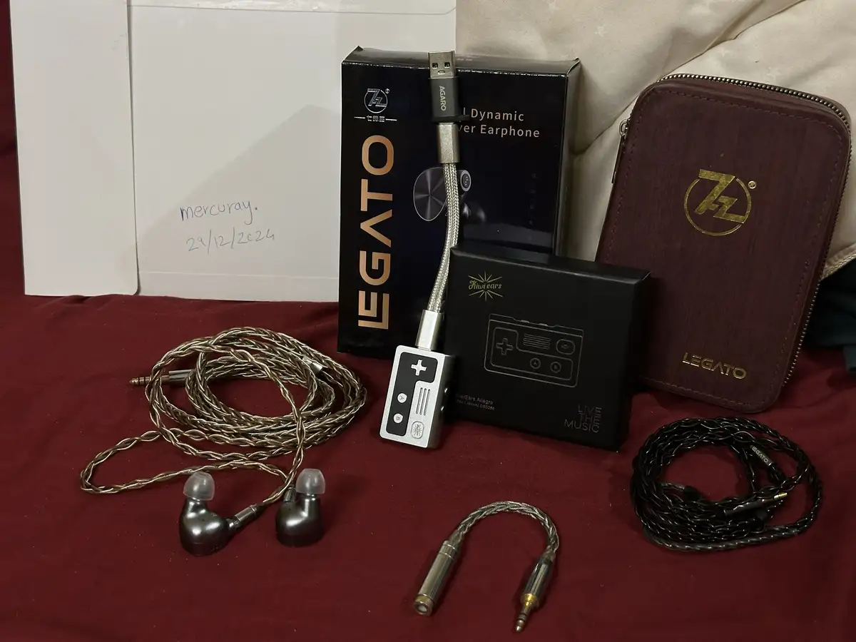 A collection of high-end audio gear, including LEGATO earphones, a KiwiEars Allegro portable player shaped like a game…