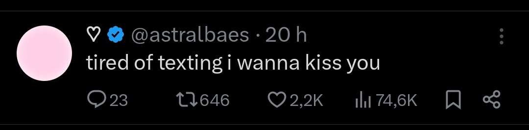 A screenshot of a tweet from verified user @astralbaes, posted 20 hours ago, showing the text 'tired of texting i wanna kiss…