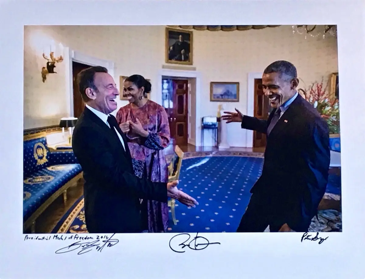 A formal photo shows former President Barack Obama laughing and gesturing toward actor and comedian Frank Langella, who is…