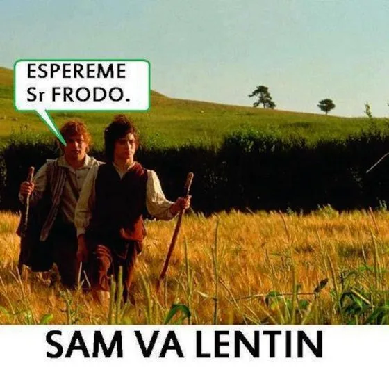 Two men in medieval-style clothing walk through a field of tall grass, one behind the other. A speech bubble above the front…
