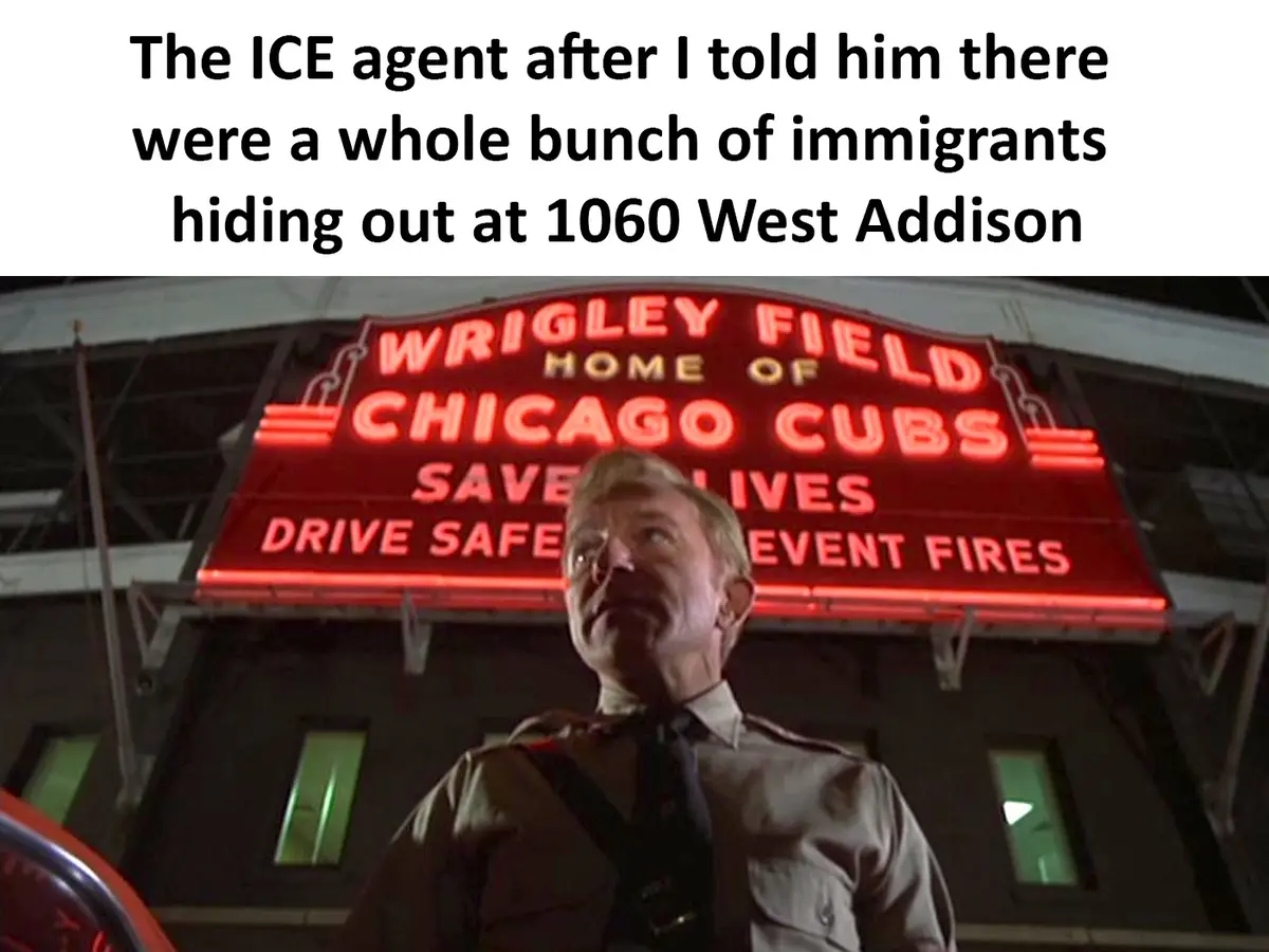A man in a uniform stands in front of a large red neon sign for Wrigley Field, home of the Chicago Cubs, with the text 'SAVE…