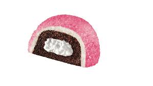 a half of a pink, sugar-coated chocolate roll with a white cream filling is shown against a plain white background. The…