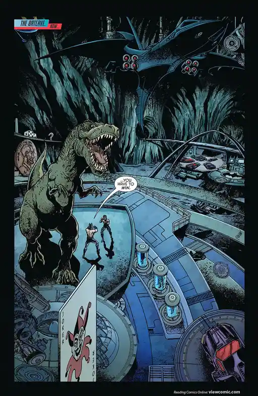 A comic panel shows a giant T-Rex standing in the Batcave, roaring at Batman and Robin who are fighting on a platform below…