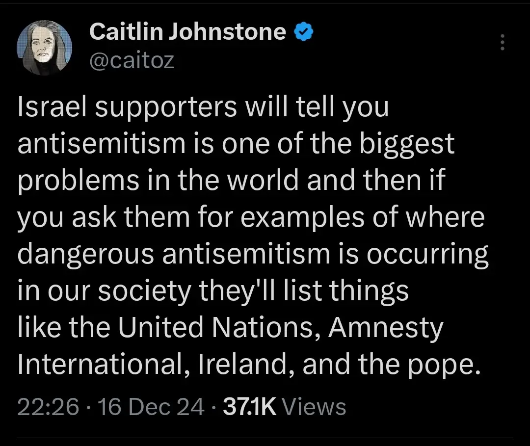 A screenshot of a tweet by verified user Caitlin Johnstone (@caitoz) with white text on a black background. The tweet…