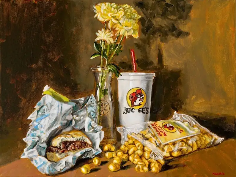 A still life painting depicts a Buc-ee's branded drink cup with a red straw, a partially eaten sandwich in foil, spilled…