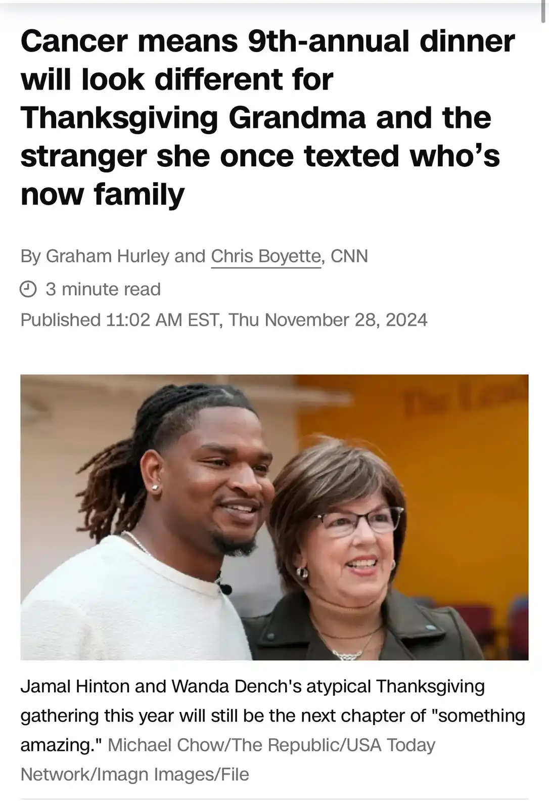 A screenshot of a CNN news article shows a photo of a smiling Black man with dreadlocks and a smiling white woman with…