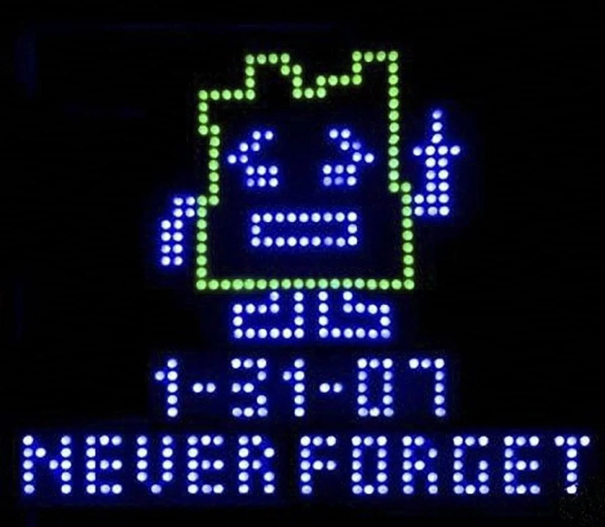 A digital LED display shows a pixelated image of a computer monitor with the text '6:34' above '2:15' and the date '1-31-07'…