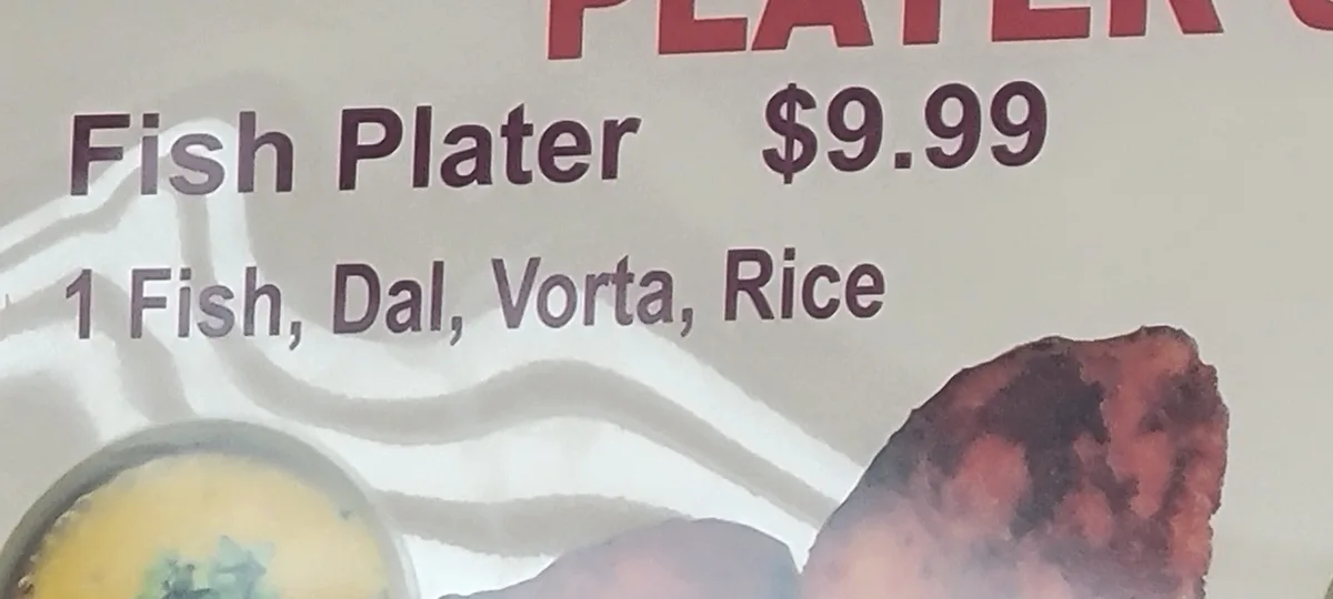 A close-up of a restaurant menu item labeled 'Fish Plater $9.99', listing ingredients as '1 Fish, Dal, Vorta, Rice'. The…