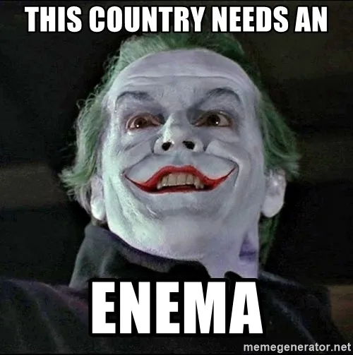 A close-up of the Joker from the movie 'The Dark Knight' with white face paint, red lips, and green hair, looking upward…