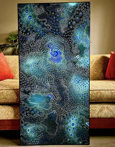 A large, vertically oriented abstract painting featuring intricate patterns of blue and white dots and swirls on a dark…