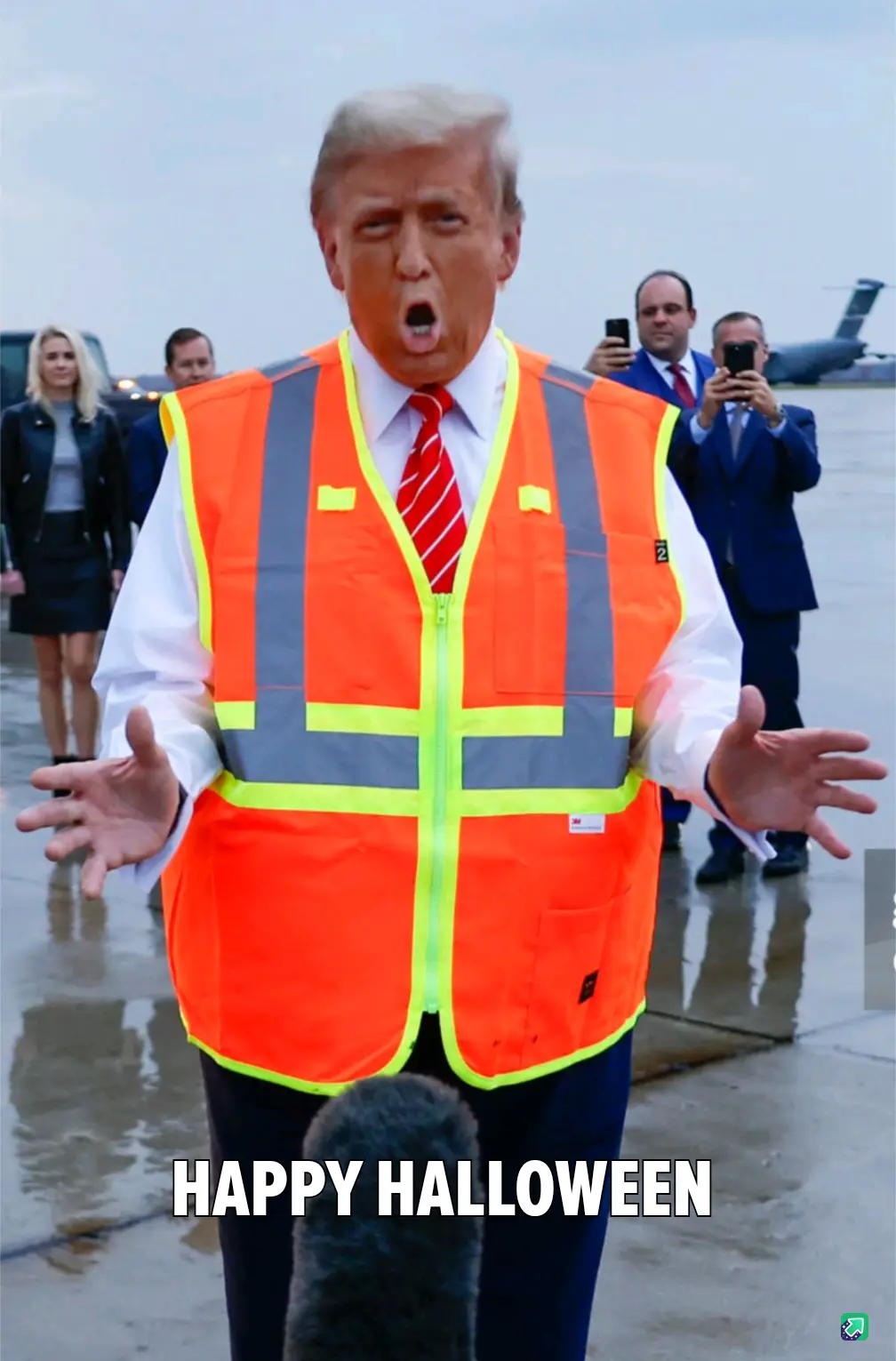 A man in a bright orange construction vest over a white shirt and red tie stands with his mouth open and hands outstretched…