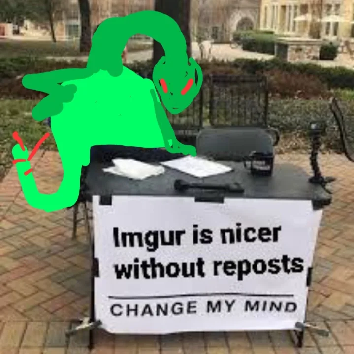 A green cartoon alien with red eyes is drawn slumped over a black folding table outdoors. On the table is a white sign with…