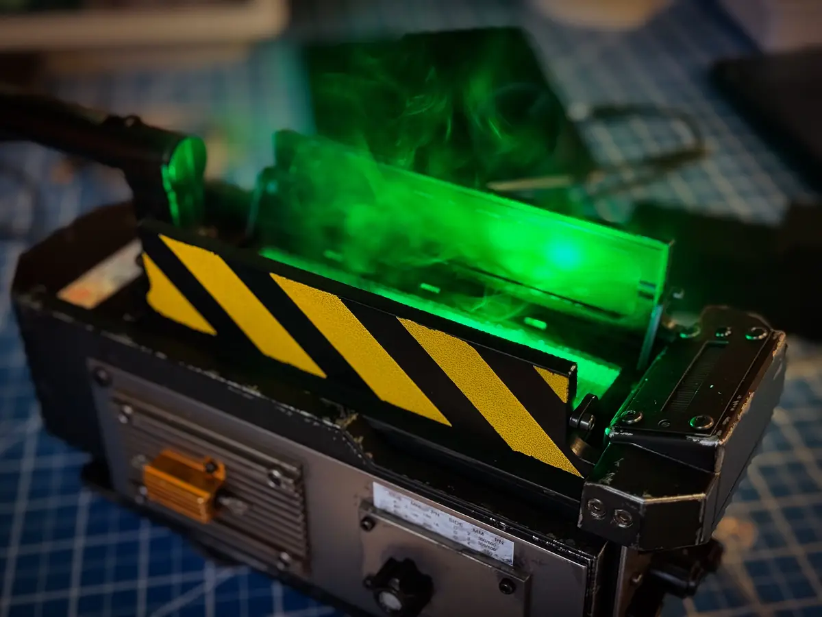 A close-up photo of a computer component, likely a graphics card or RAM stick, emitting green smoke while being held in a…