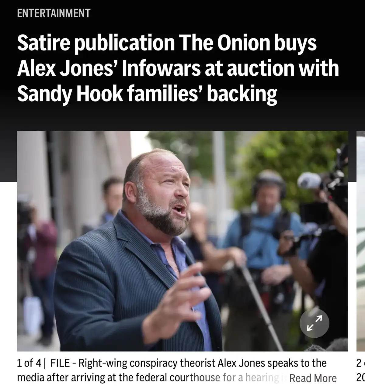 The image shows Alex Jones speaking to the media outdoors, surrounded by reporters and cameras. The overlaid text reads…