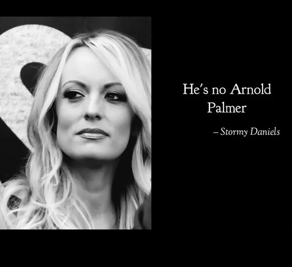 A black-and-white photo of Stormy Daniels, who has blonde hair and is wearing a large, textured heart-shaped accessory…
