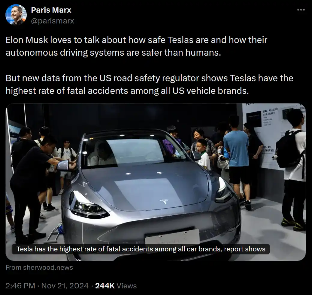 A silver Tesla Model Y is displayed at an auto show, surrounded by people examining it. Overlaid text states that Tesla has…