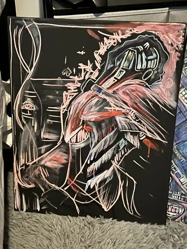 A chaotic, abstract painting on a black canvas depicts a monstrous, screaming figure with exaggerated teeth and limbs…
