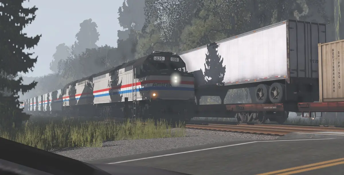 An Amtrak passenger train, locomotive number 330, is shown on tracks with freight cars, including a white trailer and a…