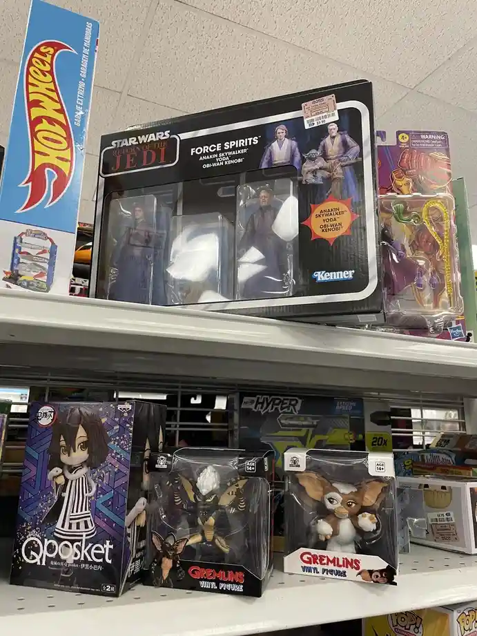 A store shelf displays various action figures, including a Star Wars 'Force Spirits' set featuring Anakin Skywalker, Yoda…