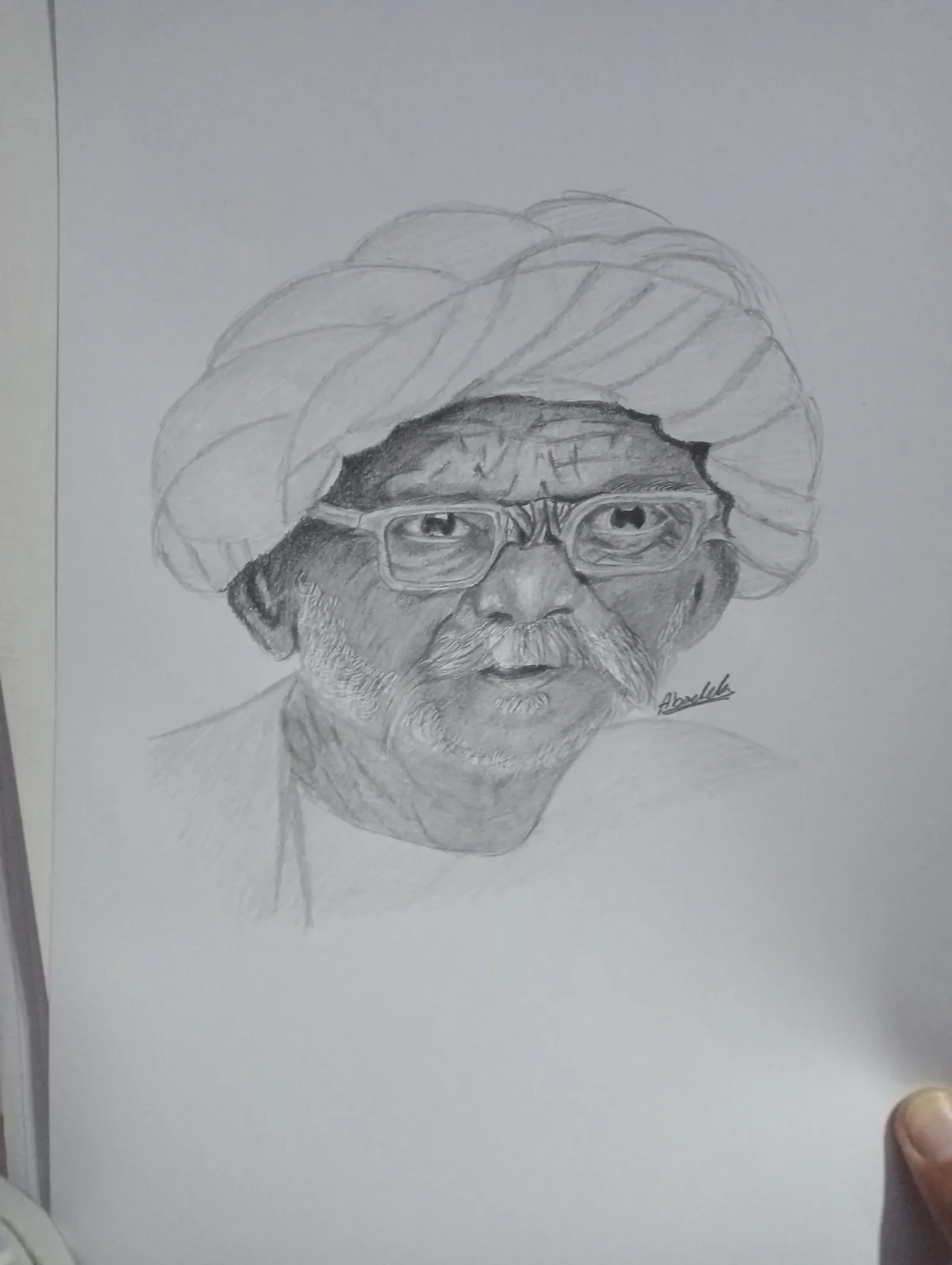 A pencil sketch of an elderly man with a turban, glasses, and a mustache, signed 'Aboulela' in the lower right corner. The…
