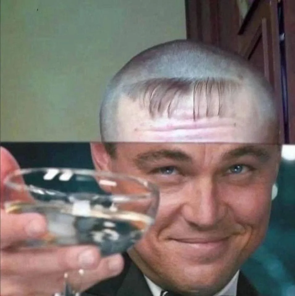A close-up image of Leonardo DiCaprio smiling while holding a glass of champagne. His head is digitally edited to have a…