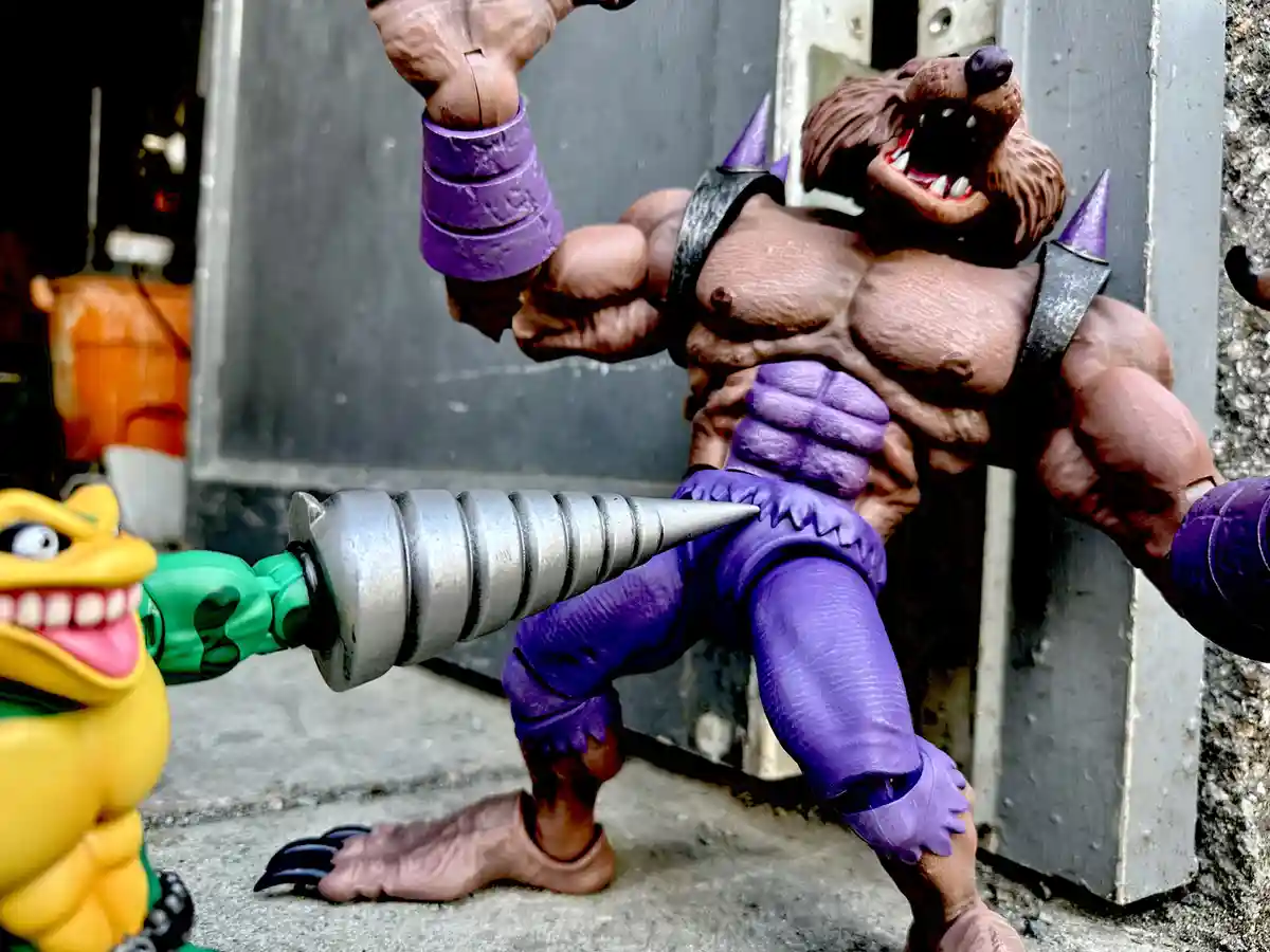 A muscular, brown-furred werewolf action figure with purple armor and spiked shoulder pads is being attacked by a yellow…