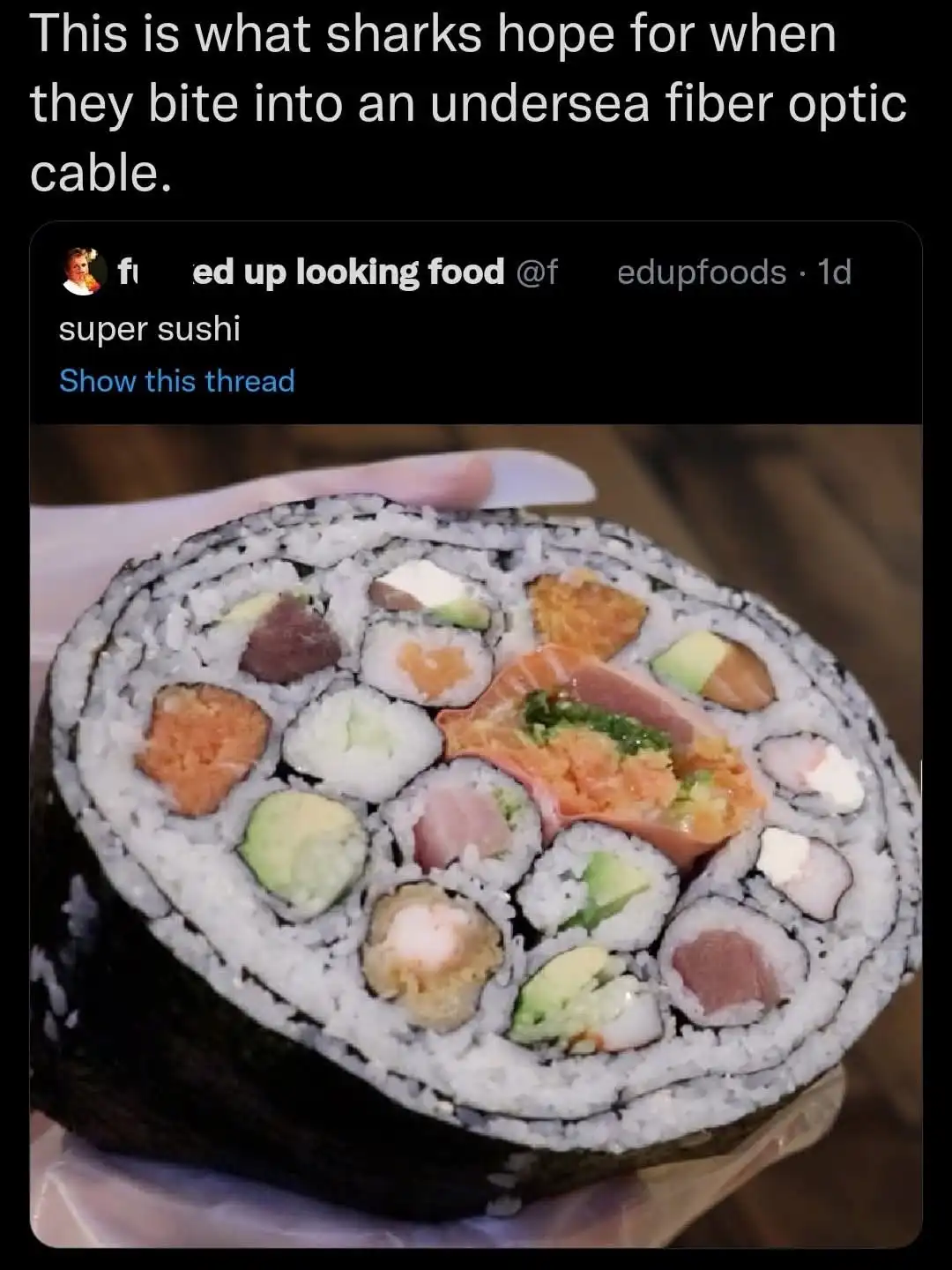 A cross-section of a large, colorful sushi roll with various fillings like salmon, avocado, tuna, and crab, held in a hand…