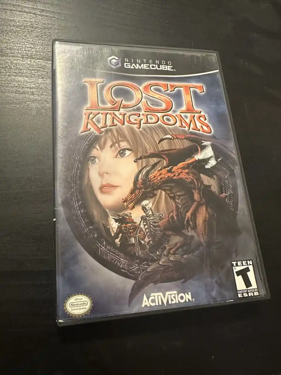 A physical Nintendo GameCube game case for 'Lost Kingdoms' by Activision, featuring artwork of a woman with a dragon and…