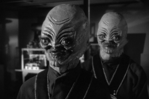 Two black-and-white stills of alien characters from the 1950s sci-fi film 'The Thing from Another World' are shown, with the…