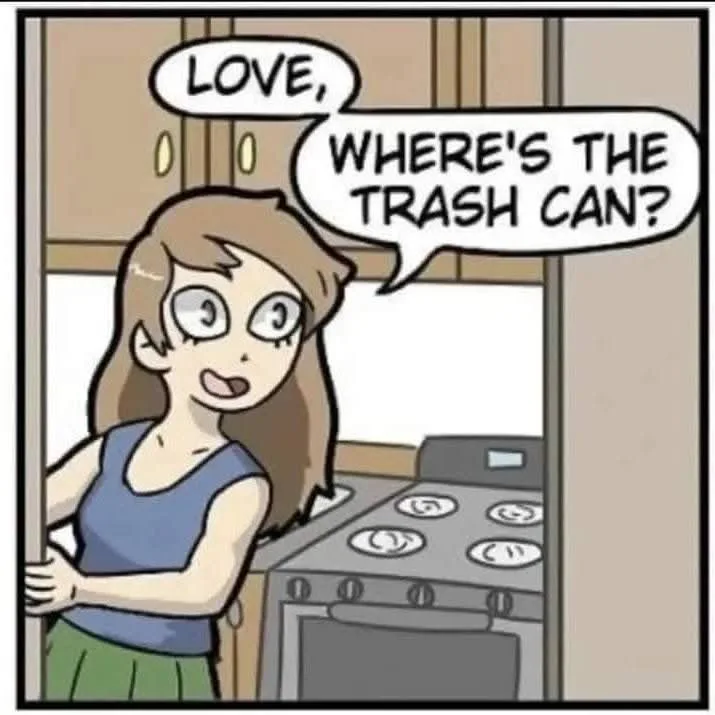 A cartoon woman with wide eyes and a surprised expression stands in a kitchen, asking 'LOVE, WHERE'S THE TRASH CAN?' in…