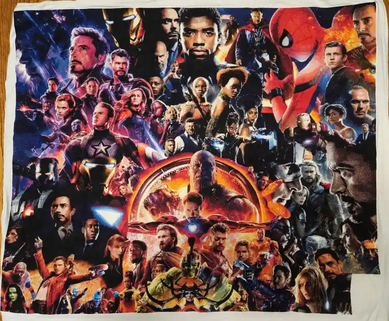 A close-up photo of a white towel printed with a dense collage of Marvel superhero characters from the 'Avengers: Endgame'…