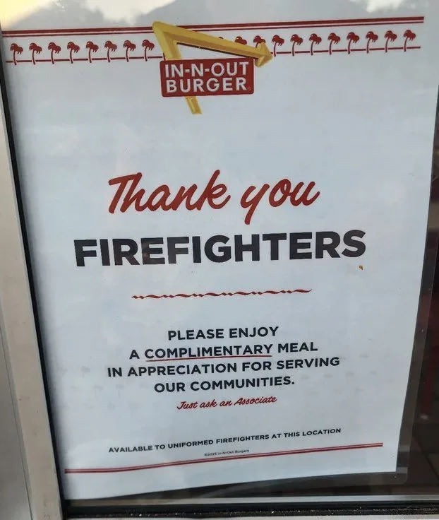 A sign from In-N-Out Burger thanks firefighters and offers them a complimentary meal by asking them to 'just ask an…
