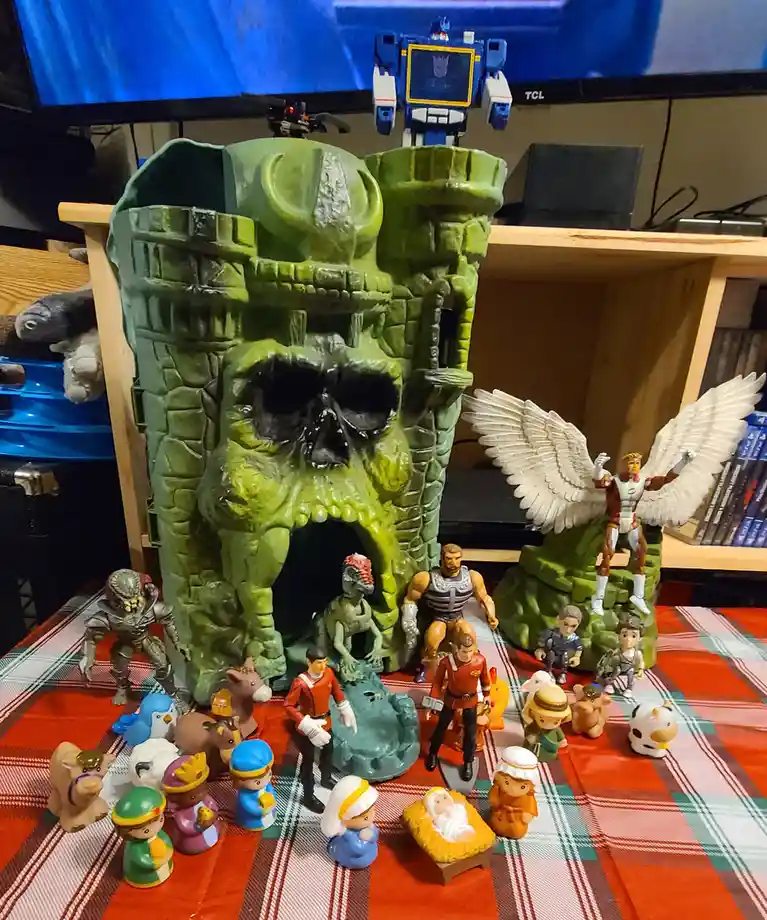 A nativity scene featuring traditional figures like Mary, Joseph, and the baby Jesus in a manger, surrounded by Star Trek…