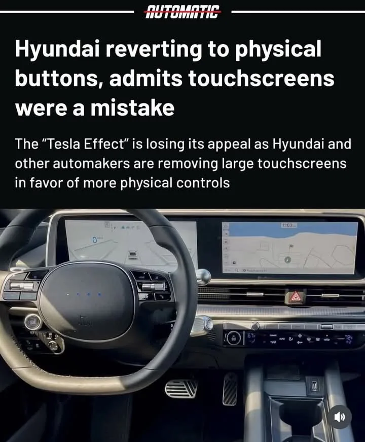 The image shows the interior of a modern car, focusing on the dashboard with two large touchscreen displays above the…