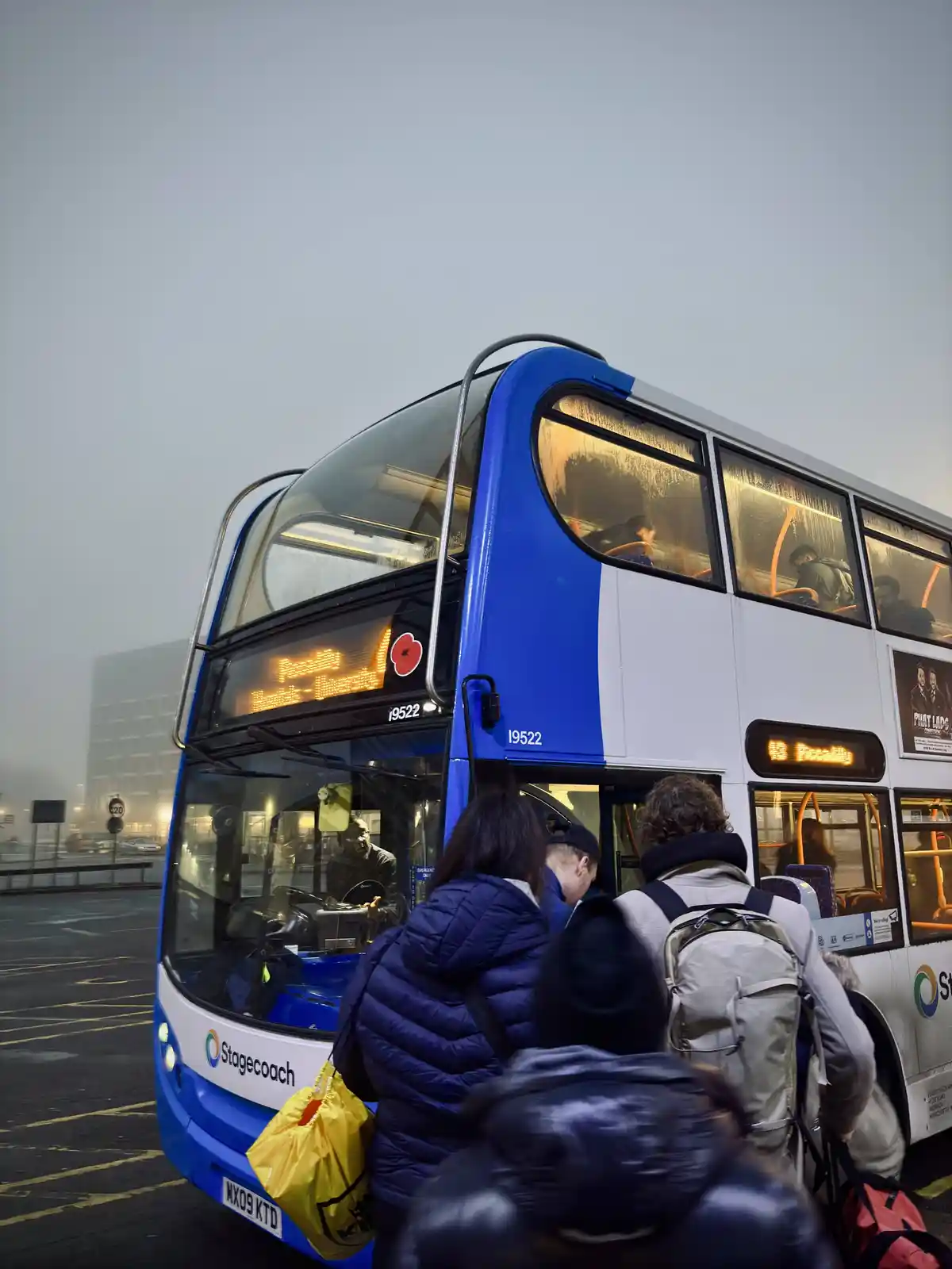 A blue and white double-decker bus with 'Stagecoach' branding and route number 19522 is shown with passengers boarding. The…