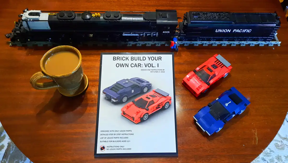 A wooden table displays a book titled 'BRICK BUILD YOUR OWN CAR: VOL. I' with images of two LEGO cars, alongside three…