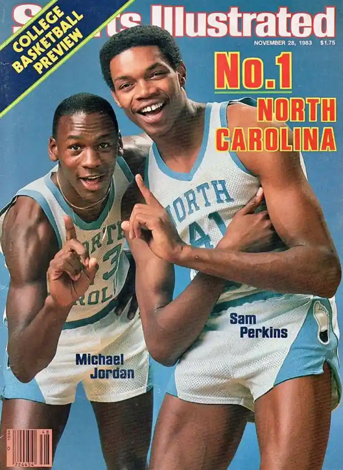 The cover of Sports Illustrated from November 28, 1983, features two smiling North Carolina basketball players, Michael…