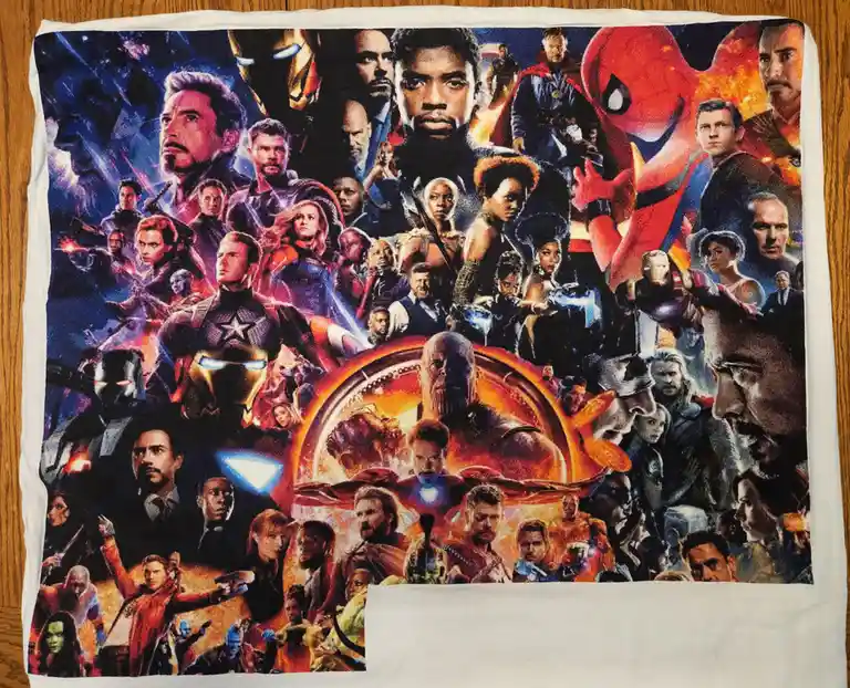A white towel laid flat on a wooden surface features a full-color, high-resolution print of the 'Avengers: Endgame' movie…