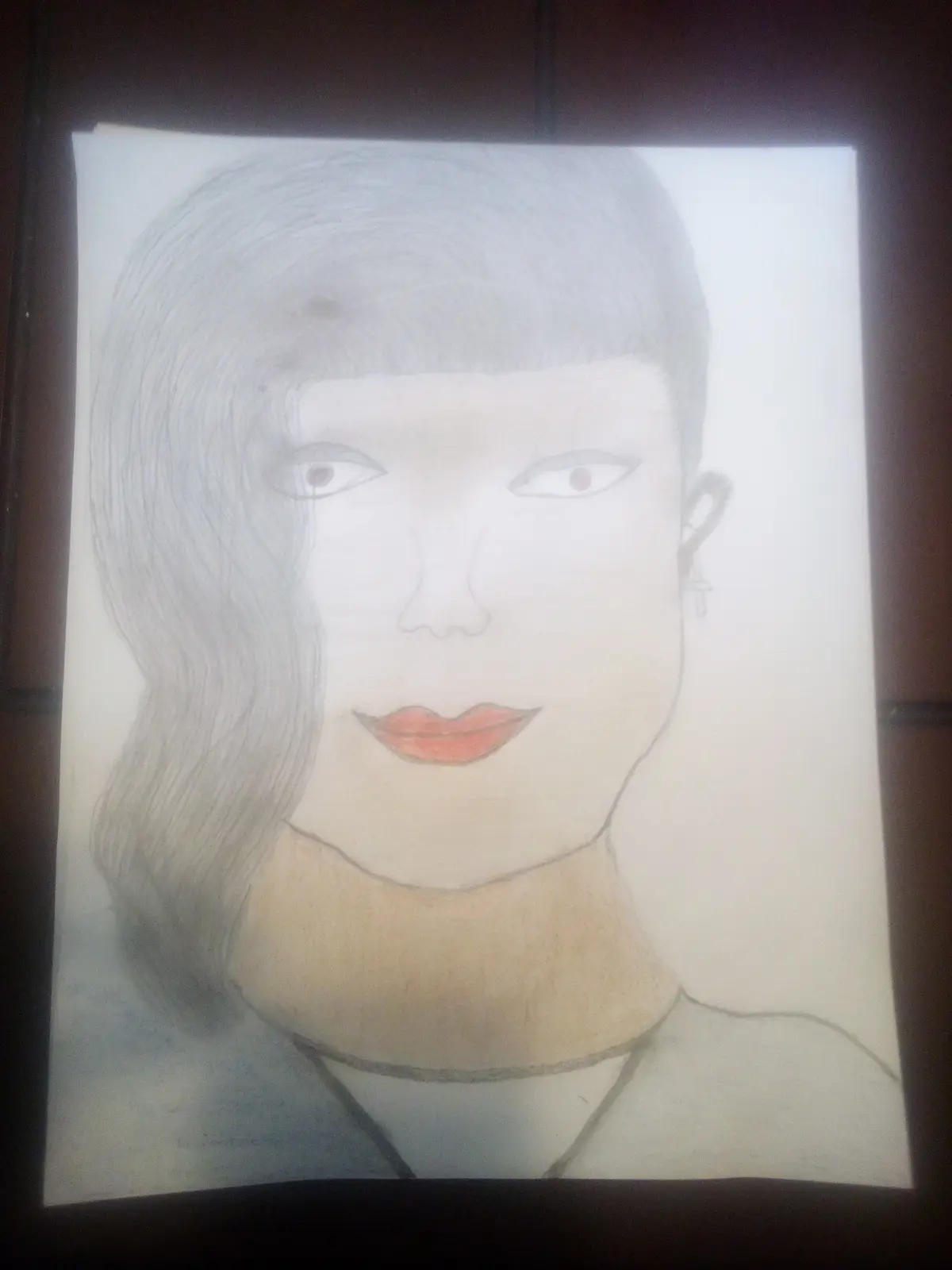 A hand-drawn portrait on paper depicts a woman with short, wavy hair, a cross earring, and distinct red lips, rendered…